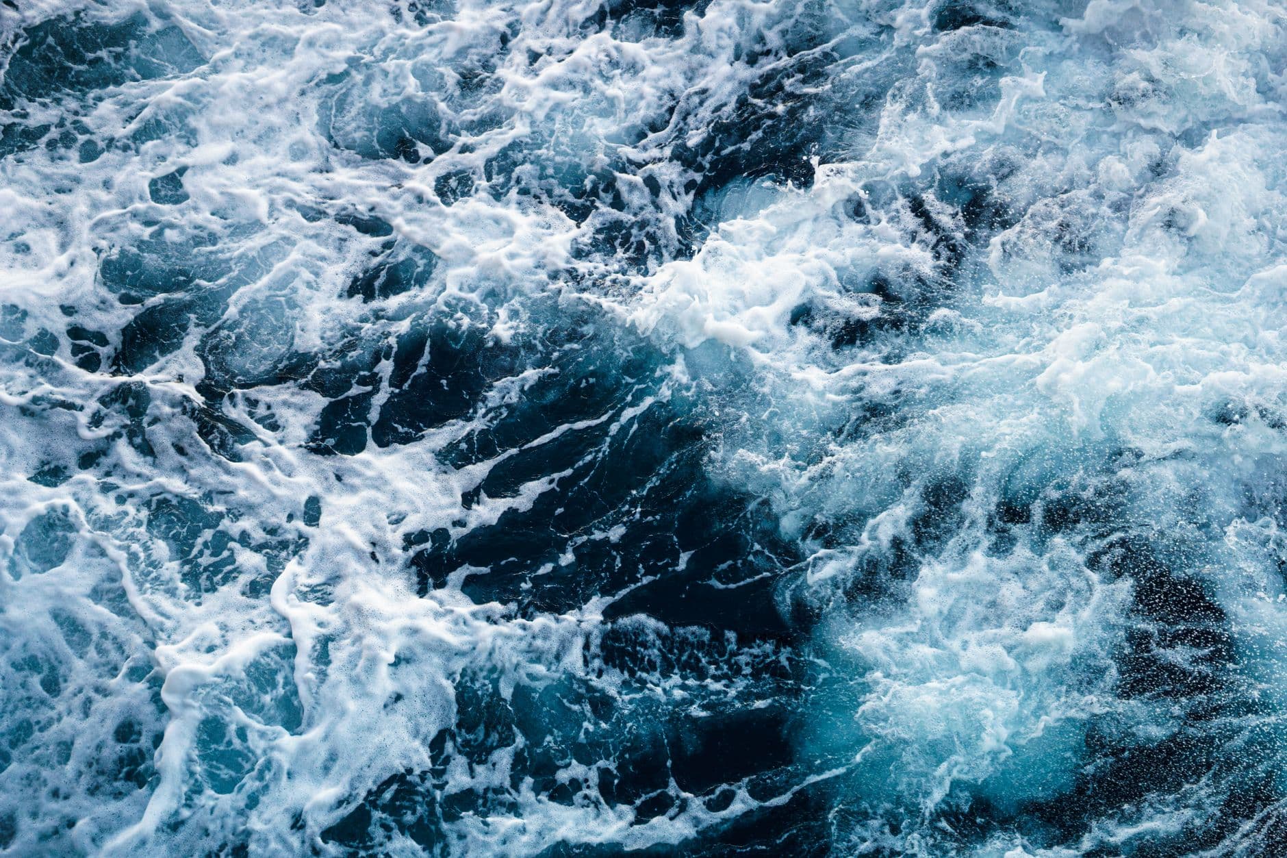 Turbulent ocean waves with white foam crashing, photographed from above, showing rough seas typical of high-latitude storm conditions. - Photo by Nothing Ahead on Pexels