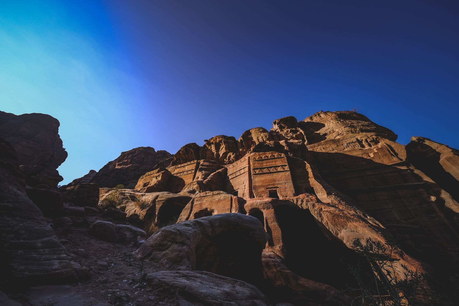 The Treasury (Al-Khazneh) at Petra, Jordan, carved directly into rose-red sandstone cliffs, photographed against a clear blue sky in what appears to be winter or dry season light. - Photo by Francesco Ungaro on Pexels